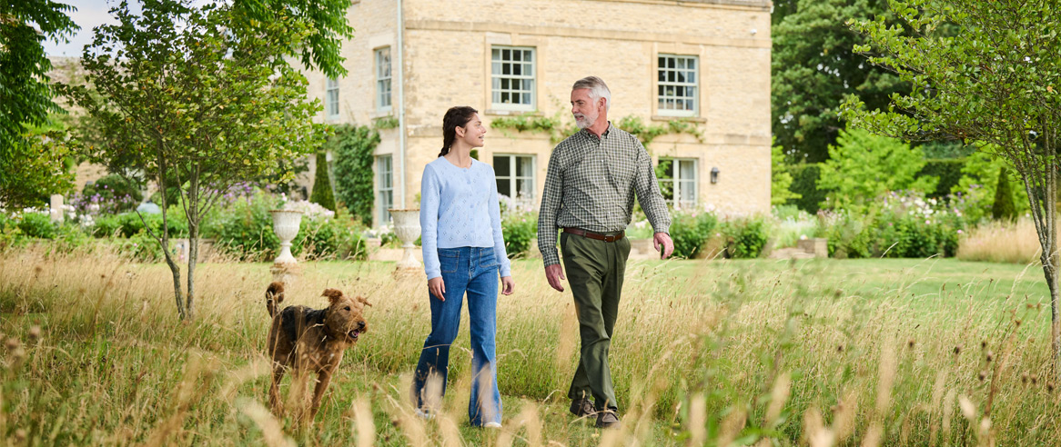 A couple walking through a garden